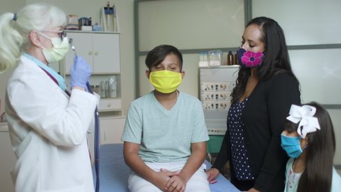 The COVID19 pandemic has made wearing protective face masks the new normal even for routine doctor visits for this mom and her children.