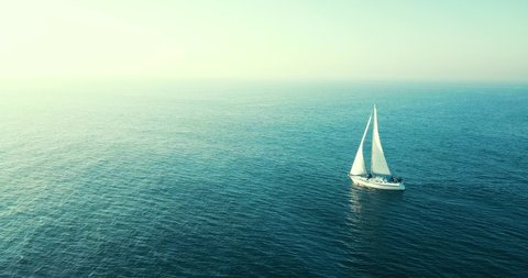 Drone Shot of Sail Boat Traveling in Calm Waters in Pacific Ocean with Blue Skies