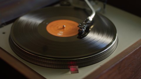 A vinyl record ends side A and gets flipped to side B