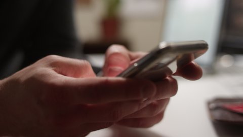 Close up of thumbs texting on a smartphone with shallow focus