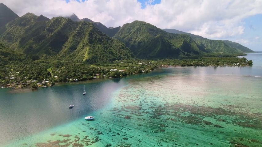 Flying over ocean coastal mountain landscape of Teahupoo, Tahiti. Drone aerial shot. Tropical paradise. French Polynesia 4k. Royalty-Free Stock Footage #1058448346