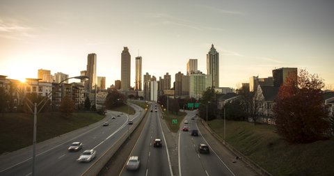 Atlanta skyline changing from day to night and traffic flowing