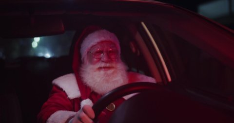 Santa Claus annoyed in car stuck in traffic. 4K.