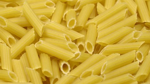 Pasta (macaroni) background rotation. Close up. Top view