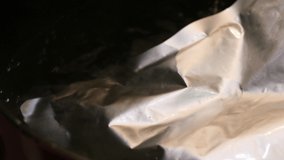 A sealed pouch with curry. Video of warming in a pan.
