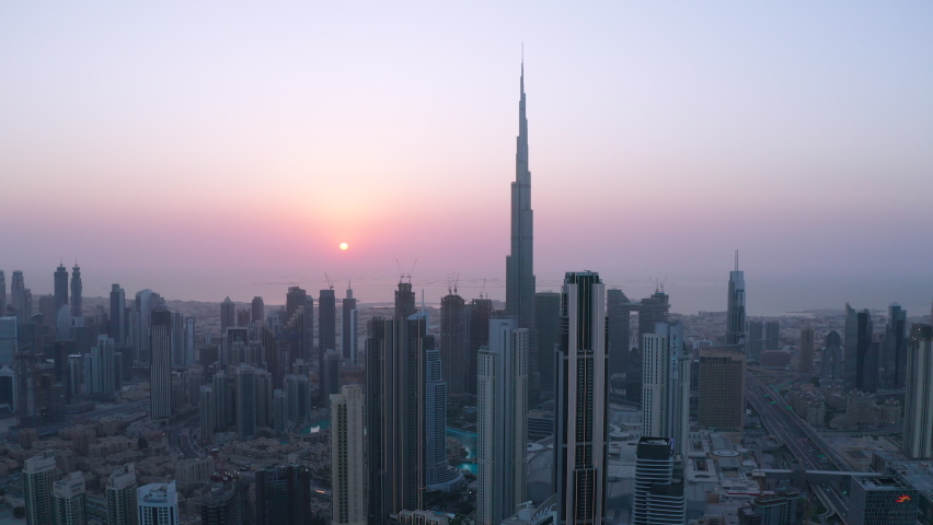 Amazing panning aerial video shot of Downtown Dubai commercial area high rise skyscrapers during sunset in modern futuristic city district - Dubai, UAE - Sep 2020 | Shutterstock HD Video #1058465608