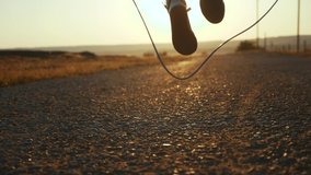 child jumping on a skipping rope close-up legs slow motion video silhouette. happy family kid dream concept. baby feet jumping on a skipping rope. girl in sneakers sunset play a skipping rope - Powered by Shutterstock - Get 15% off with code: PIKWIZARD15
