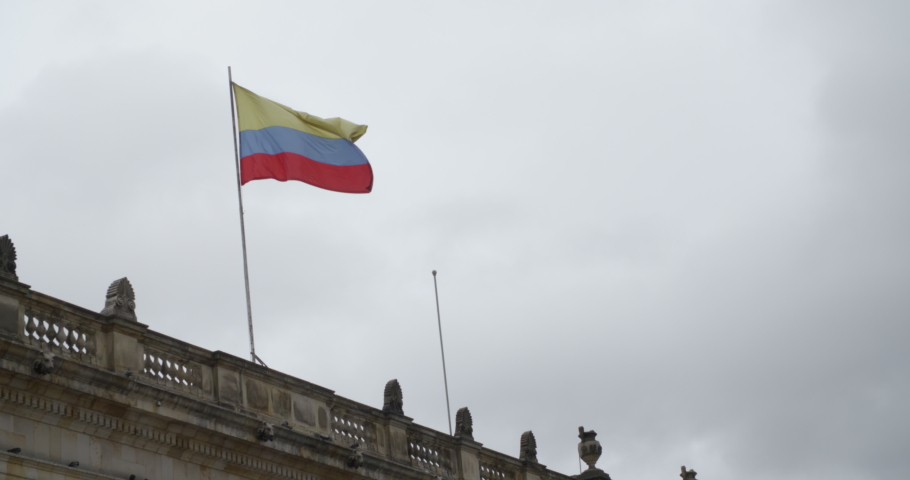Colombian flag waving on a building in Bogota, Colombia city square.