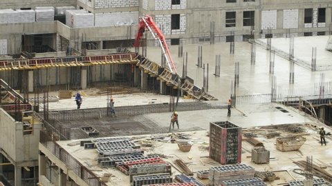 Time lapse of workers at large construction site pour and level concrete. Advanced building technology and modern monolithic construction. Сonstruction industry