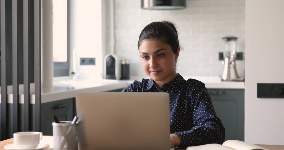 Indian satisfied woman sit at homeoffice accomplish work on laptop relaxing puts hands behind head. Lady daydreaming finished task feel peace of mind, think of future success and opportunities concept Royalty-Free Stock Footage #1058470576