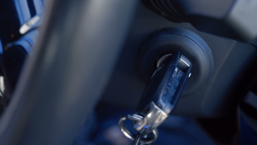 Added shaking from moving the car! The driver inserts the ignition key into the ignition lock, turns it and starts the engine, then turns off the engine and removes the key. Closeup | Shutterstock HD Video #1058473540