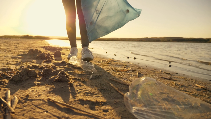  Volunteers collect trash in a trash bag. Plastic pollution and environmental problem concept. Voluntary cleaning of nature from plastic Royalty-Free Stock Footage #1058473810
