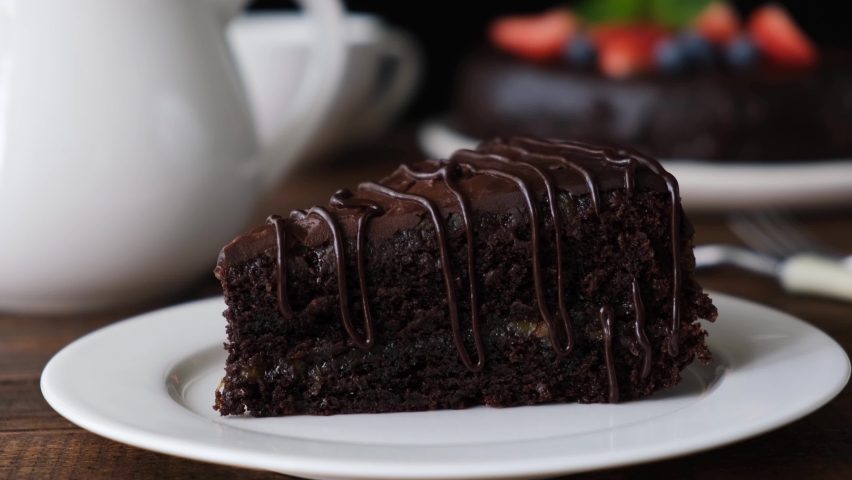 Eating chocolate cake. Taking ]bite of moist delicious chocolate cake with a fork | Shutterstock HD Video #1058474194