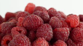 Eco bright colorful berry raspberry rotates 360 on a white background. Close-up of loose raspberry slide 4K video
