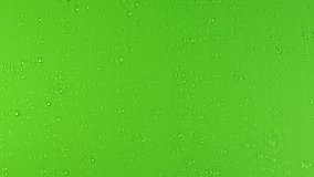 Drops trickling down on green background. Rain Drops Stock Footage in 4K. Droplets of water on green glass background. Rain Drops Falling down on green background. Close up drops on glass or bottle. - Powered by Shutterstock - Get 15% off with code: PIKWIZARD15