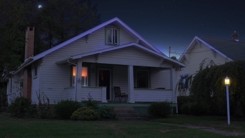 A night or dusk wide establishing shot of a typical middle class New England home. Various lights turn on and off. Moon in the distance. Pittsburgh suburbs. Day winter versional available. Royalty-Free Stock Footage #1058475892
