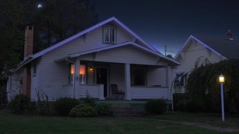 A night or dusk wide establishing shot of a typical middle class New England home. Various lights turn on and off. Moon in the distance. Pittsburgh suburbs. Day winter versional available.