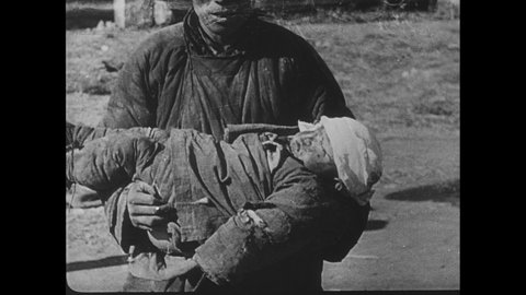 1940s China: Man holds dead child. Woman sits by body, cries. Boy pulls on woman. Doctor holds man's arm. Injured boy. Girl with badly broken arm. Doctor examines man's neck. Badly injured man.