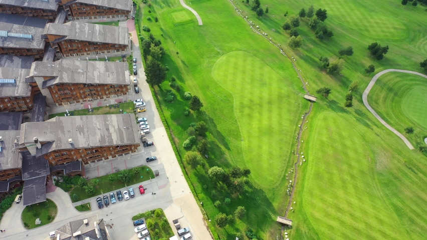 Bulgaria, a village in Balkan Pirin mountains with green golf courses. Aerial shoot.