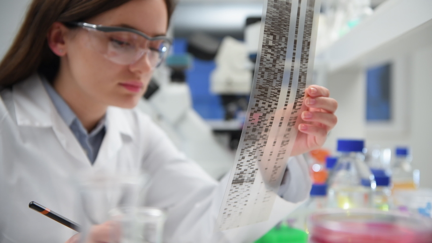 Scientist examining DNA autoradiogram in laboratory/ High Wycombe, Bucks, England, UK | Shutterstock HD Video #1058481490
