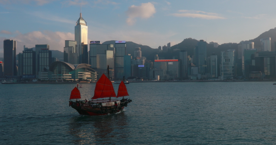 Hong Kong Central skyline and Chinese junk boat in Victoria Harbour / Hong Kong, China,Nare | Shutterstock HD Video #1058481826