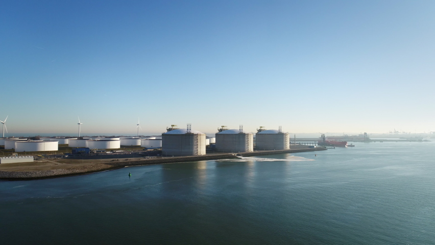 Oil storage and LNG containers in Tweede Maasvlakte, part of Rotterdam harbour / Rotterdam, Zuid-Holland, Netherlands Royalty-Free Stock Footage #1058483719