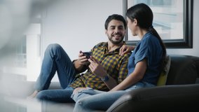 Young couple smiling, using cell phone for internet and social media. Happy man and woman holding smartphone for web site. Friends watching funny film and pictures on mobile telephone - Powered by Shutterstock - Get 15% off with code: PIKWIZARD15