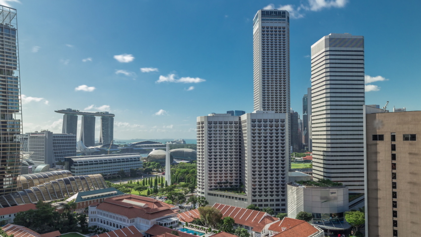 A beautiful morning panorama with Marina Bay area and skyscrapers city skyline aerial timelapse hyperlapse. The tower shape building at the North bridge road in Singapore. Royalty-Free Stock Footage #1058490397