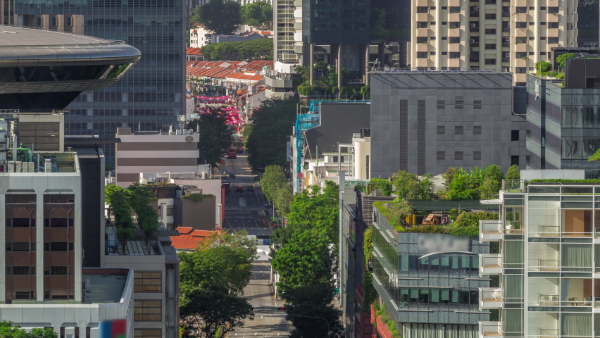 Traffic with cars on a street and urban scene in the central district of Singapore aerial timelapse. North Bridge road with Downtown skyscrapers around