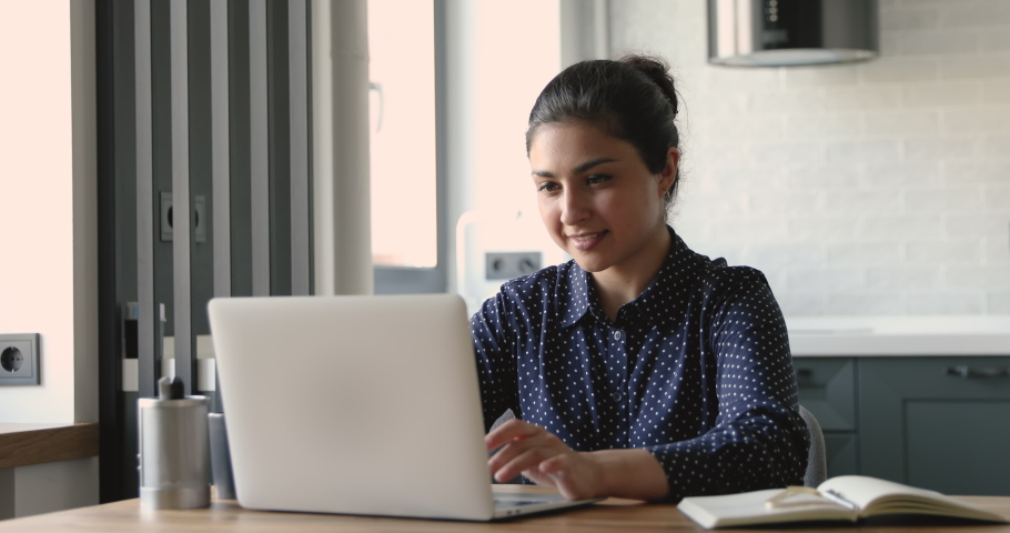 Indian woman sit at desk work on laptop feels upset has problem with device. System error, receive bad news, data loss, backup battery issue, unsaved lost important information, need pc repair concept | Shutterstock HD Video #1058494750