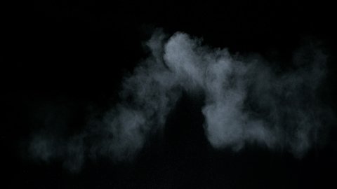 Misty chalk clouds blowing into center. Isolated super slow motion white smoke and fog wisp on black background. Studio concept and VFX plate shot for scene overlay and creative enhancement.