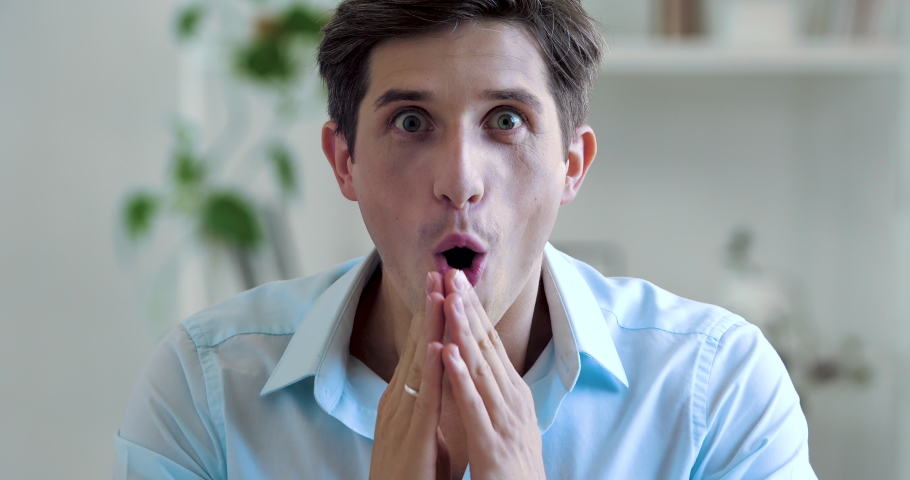 Portrait of young adult amazed man looking at camera, taking off black glasses from male face, opening his mouth eyes in surprise, feeling shock joy interest, receives unexpected good news, close up | Shutterstock HD Video #1058496907