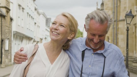 Tracking Close Up of Middle Aged Tourist Couple Exploring City