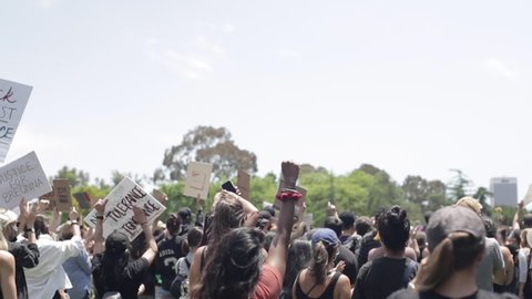 Los Angeles , CA / United States - 06 04 2020: Los Angeles, California, 04 June 2020 – Crowd of Protestors Cheer and Raise Signs at LA Black Lives Matter Rally, Slow Motion
