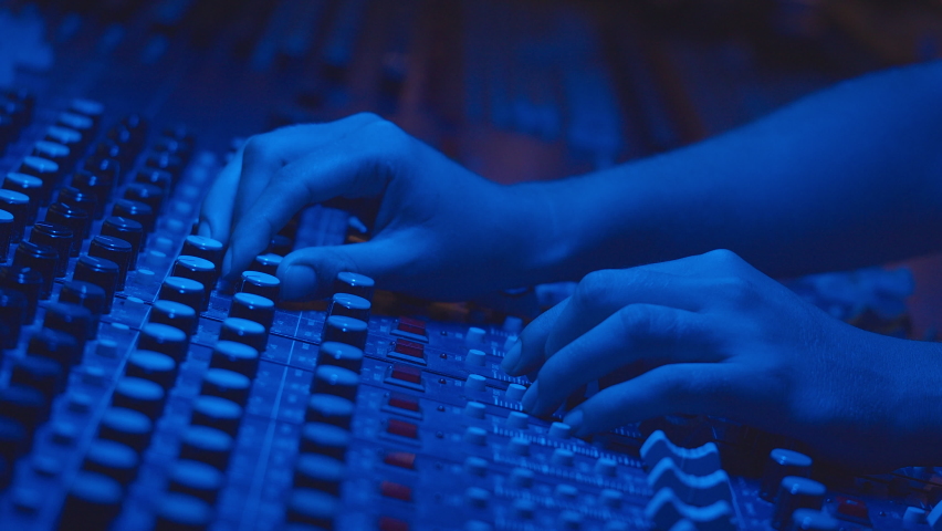 Music production studio. Producer. Close up of hands working with the sound mixer in the recording studio. Young talent produces songs.  | Shutterstock HD Video #1058505025