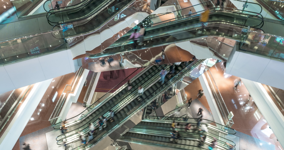 Escalator in modern multi level shopping mall crowd of people. Rush hour. Very busy full of clients mall complex. Consumption concept. Time lapse | Shutterstock HD Video #1058508085