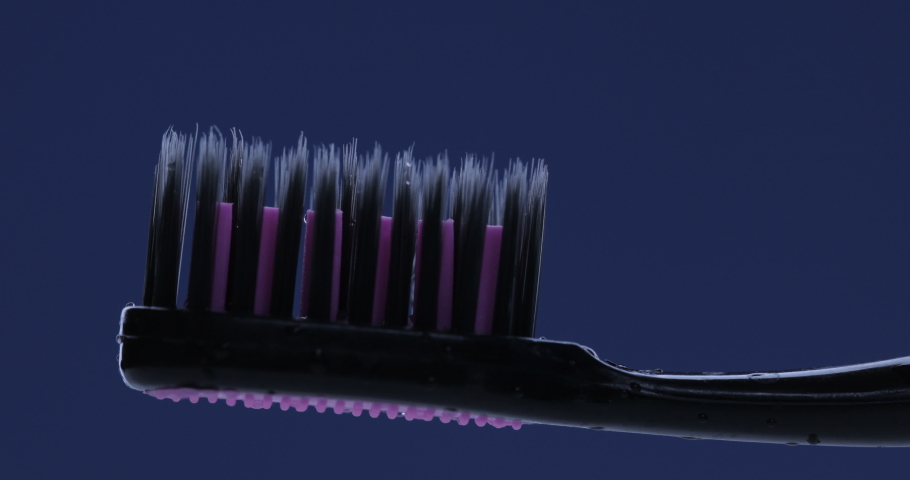 Toothpaste is applied to a toothbrush. Close up shot	
