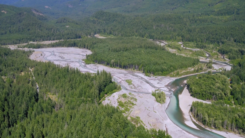 Cowlitz River Valley Flowing By The Lush Green Forest At Daytime Near The Mount Rainier National Park In Packwood, Washington, USA. - aerial tilt-up
