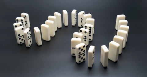 Dominoes. Chain reaction. The Domino Principle. Board game. Falling dominoes