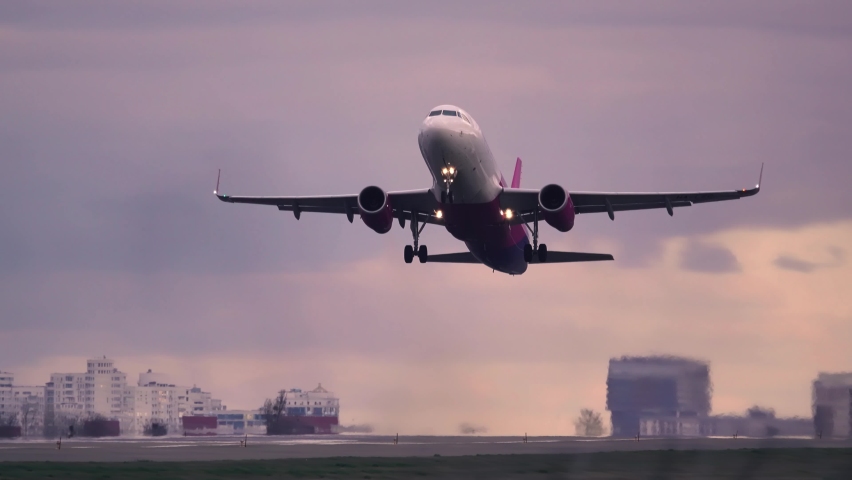 Airplane taking off at sunset. Aircraft takes off at dawn. Royalty-Free Stock Footage #1058519002
