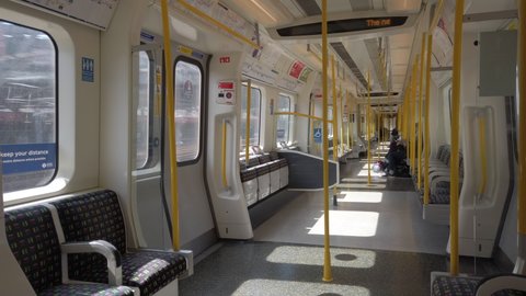 LONDON, UK - SEPTEMBER 1, 2020: Passengers inside a moving underground train on the Hammersmith & City line close to Paddington Station in London, UK.