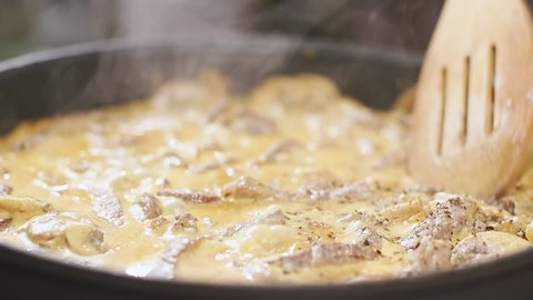 Cooking of beef stroganoff in a frying pan.
