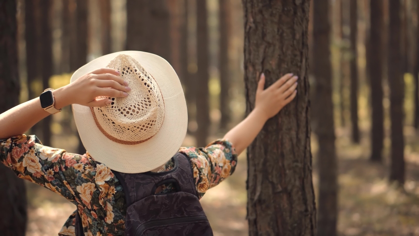 Active Woman In Hat Walking On Tree. Beautiful Healthy Girl In Dress Walking In Greenwood. Carefree Female Exploring Green Forest In Sunny Time. Holiday Vacation Tourist Trip In Forest Warm Day Royalty-Free Stock Footage #1058522236