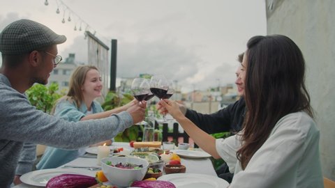 Reunion party concept, Happy friends clinking with red wine glasses smiling and laughing, Multi ethnic group of young people toasting celebrating birthday, Dinner Friendship Together in Restaurant