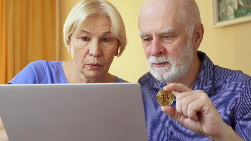 Senior couple work from home. Poor retired family went broke after online investments in cryptocurrency bitcoin and received decrease in savings value. Concept of wealth lost and financial collapse Royalty-Free Stock Footage #1058527267