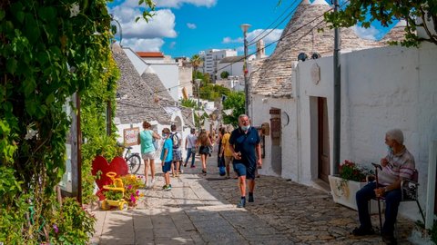 Alberobello, Italy. July 10, 2020. Timelapse view of the traditional trulli houses in Arbelobello, province Bari, region Puglia, Italy. Beautiful old town of Arbelobello with small white houses.