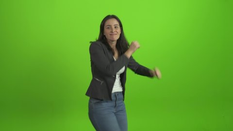 Happy smiling woman in beautiful dress dancing and having fun isolated on Green Screen, Chroma Key
