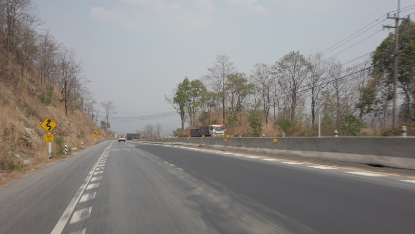 Driving along a mountine road while dry and smog season in Thailand. POV driving footage 4K