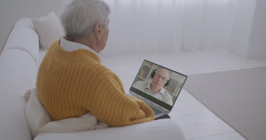 elderly man is viewing training video at laptop display, man is lecturing at webinar, modern technology Royalty-Free Stock Footage #1058550691