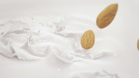 Almonds Nuts Falling Into Milk in 4K Super slow motion
